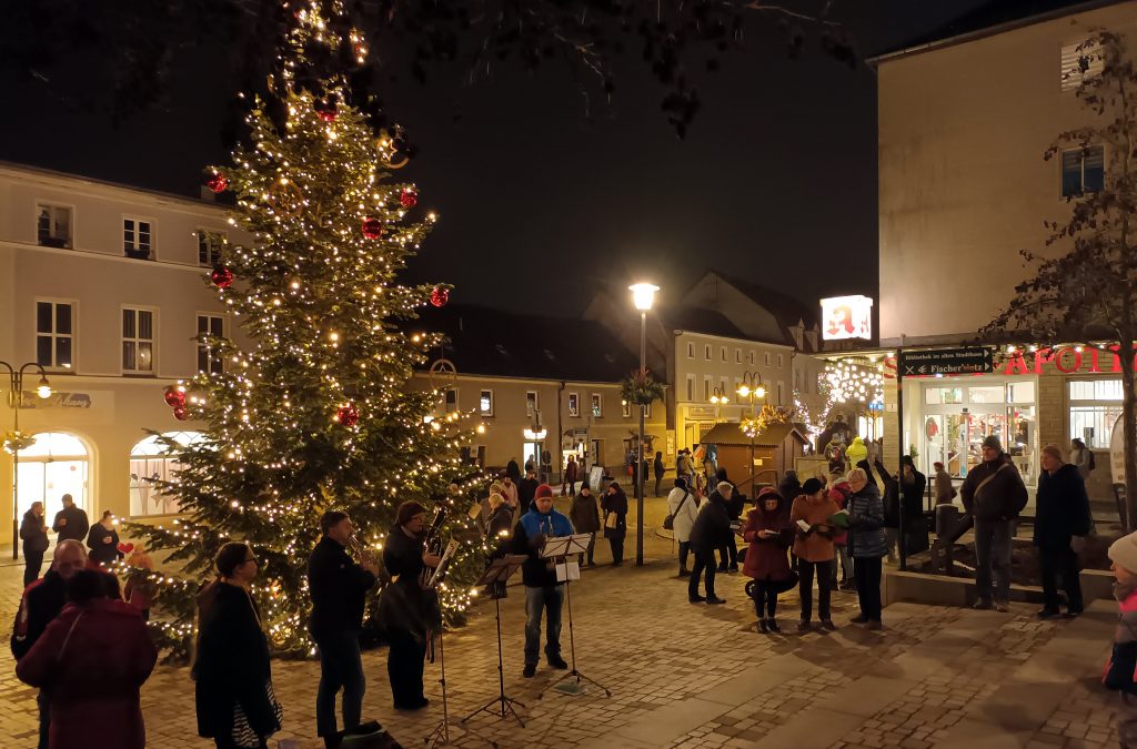 Lebendiger Adventskalender zum Weihnachtsmarktauftakt am Markt unter dem Tannenbaum mit Bläsern der Kirchengemeinde